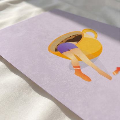 Close up view of woman diving into yellow coffee mug print showing paper texture and vibrant colors