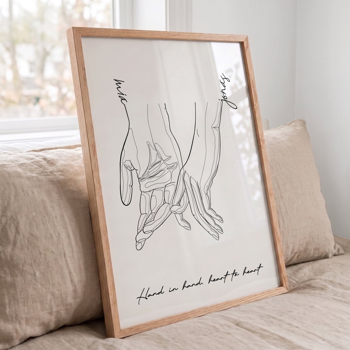 Custom couple line art print displayed in a Red Oak frame with personalized names and quote.
