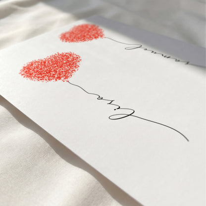 Close-up of a personalized fingerprint heart print showing custom names, elegant typography, and optional quote.