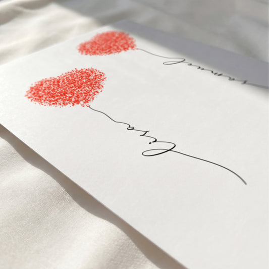 Close-up of a personalized fingerprint heart print showing custom names, elegant typography, and optional quote.