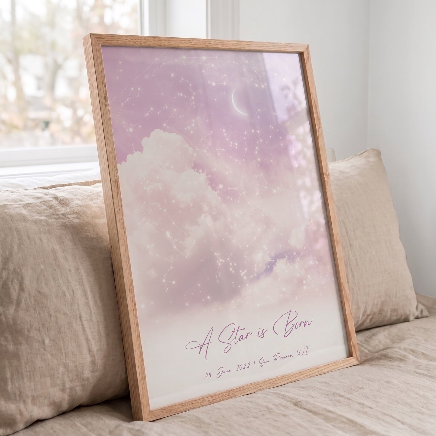 Custom night sky wall art in a Red Oak frame featuring authentic constellations and pastel clouds.