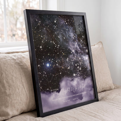 Personalized cloud background star map print leaning against a beige sofa in a bright room.