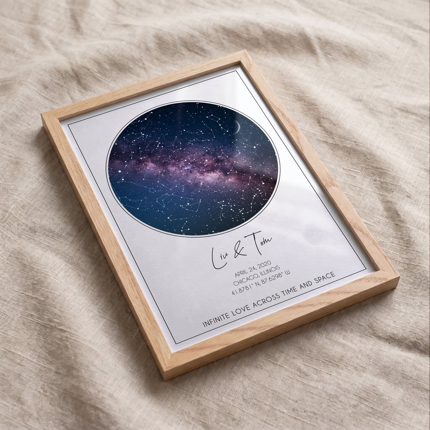 Framed personalized star map displayed on a neutral sofa with modern minimalist décor.